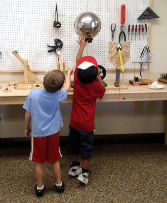 Kids explore static electricity at the grand opening of the Sanger Community Science Workshop, established by the CSW Network in September 2013 in the rural Central Valley of California.